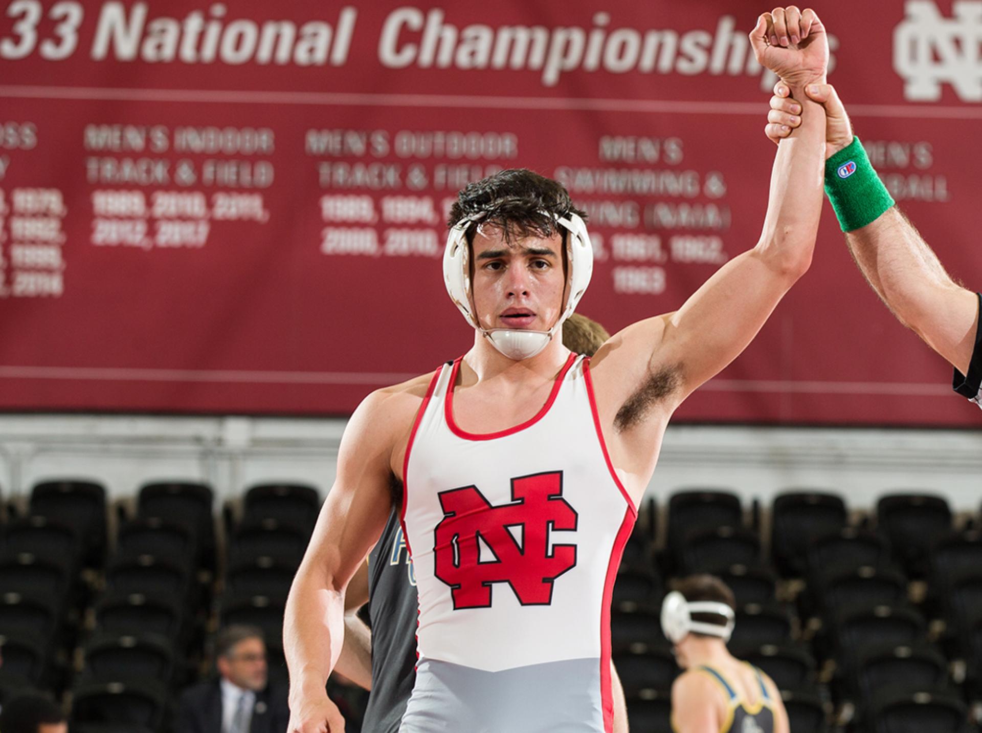 Marc Fleenor getting his hand raised after winning a match for the North Central men's wrestling team.