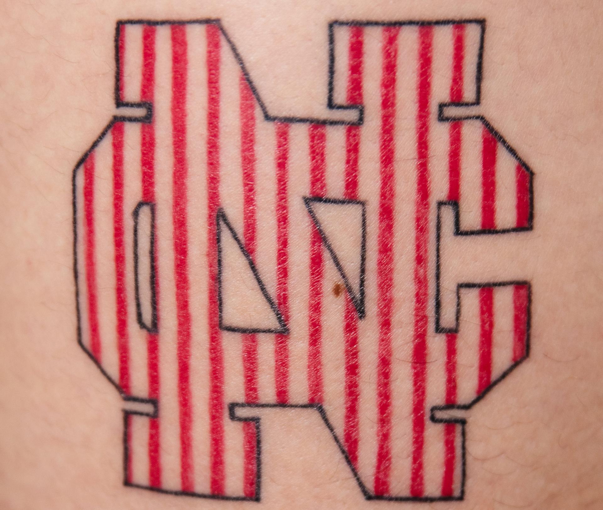 Matt Osmulski's pinstripe logo tattoo.