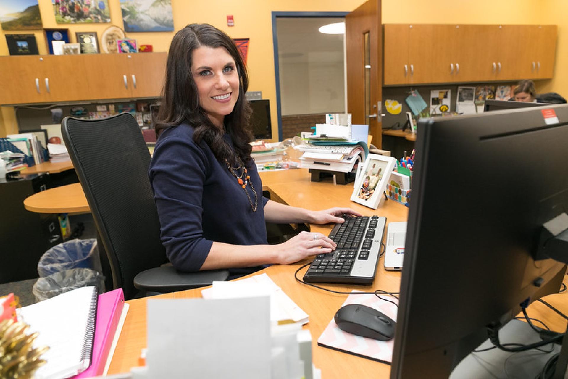 Kern fellow poses for photo at a desk