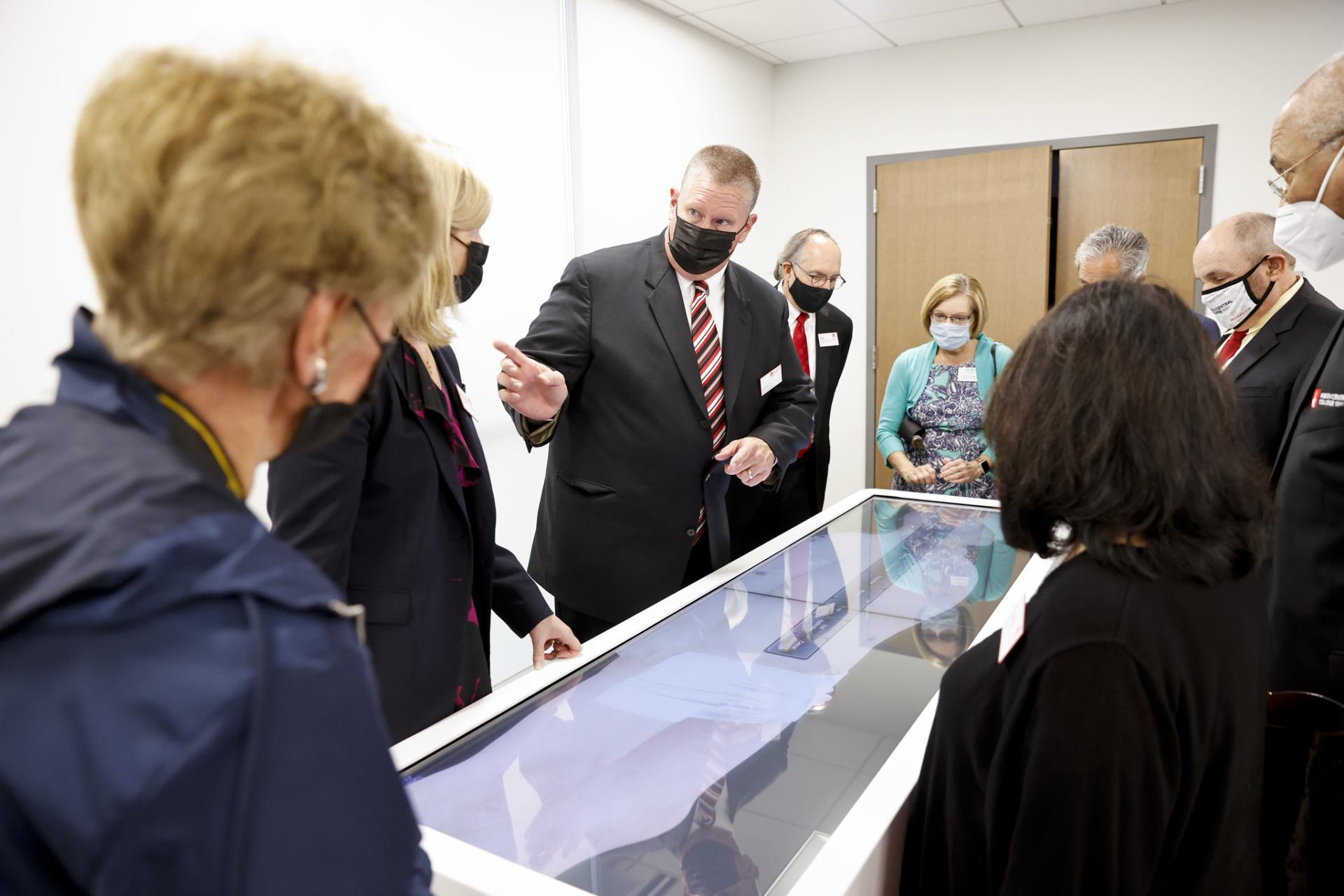 A group is shown one of the anatomage tables at the Wentz Center for Health Sciences & Engineering.