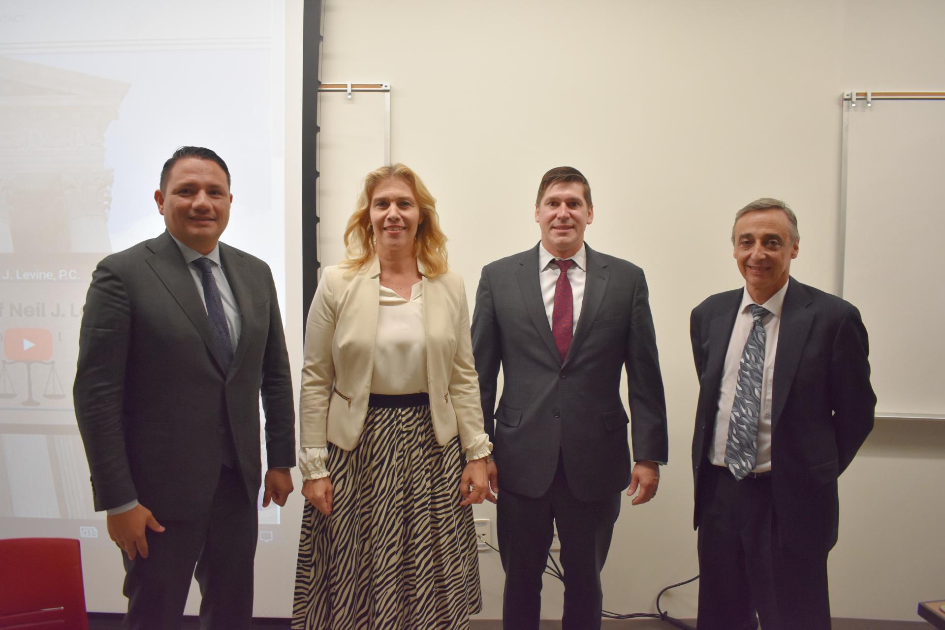 Immigration attorneys Omar Salguero, Edward Gonzalez and Neil Levine with North Central College Professor Jelena Sanchez.