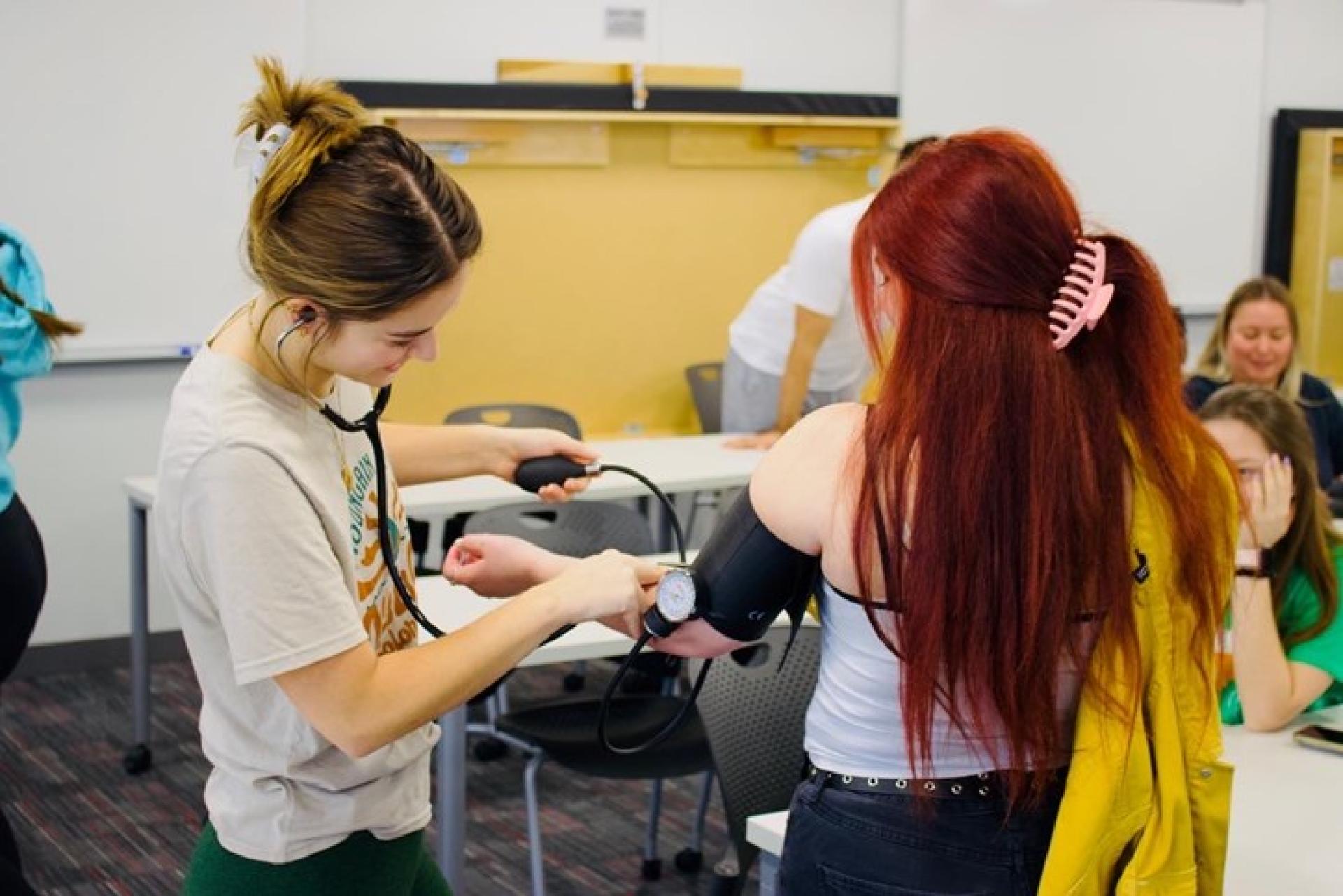 North Central physical therapy students test one another's blood pressure.