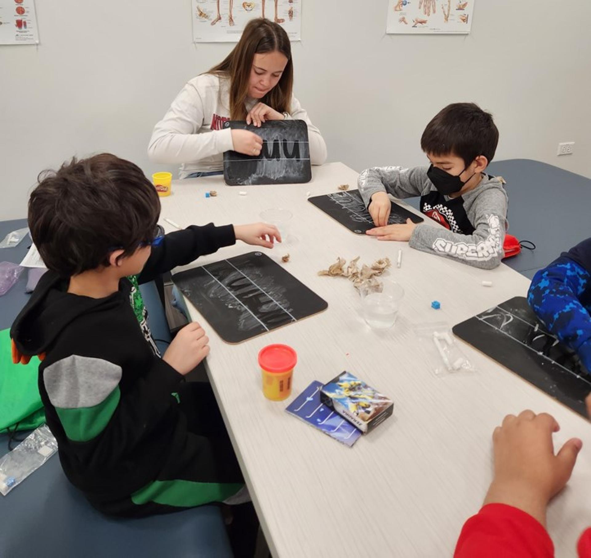 North Central College master of occupational therapy students work with children on their handwriting.