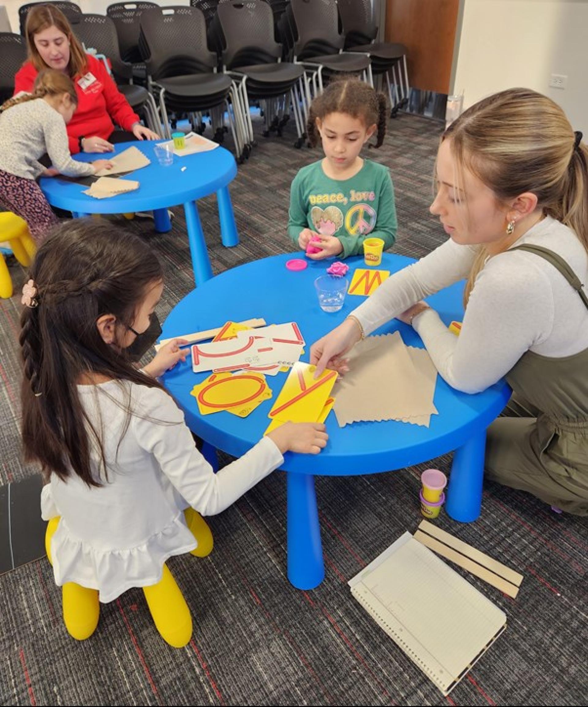North Central College master of occupational therapy students work with children on their handwriting.