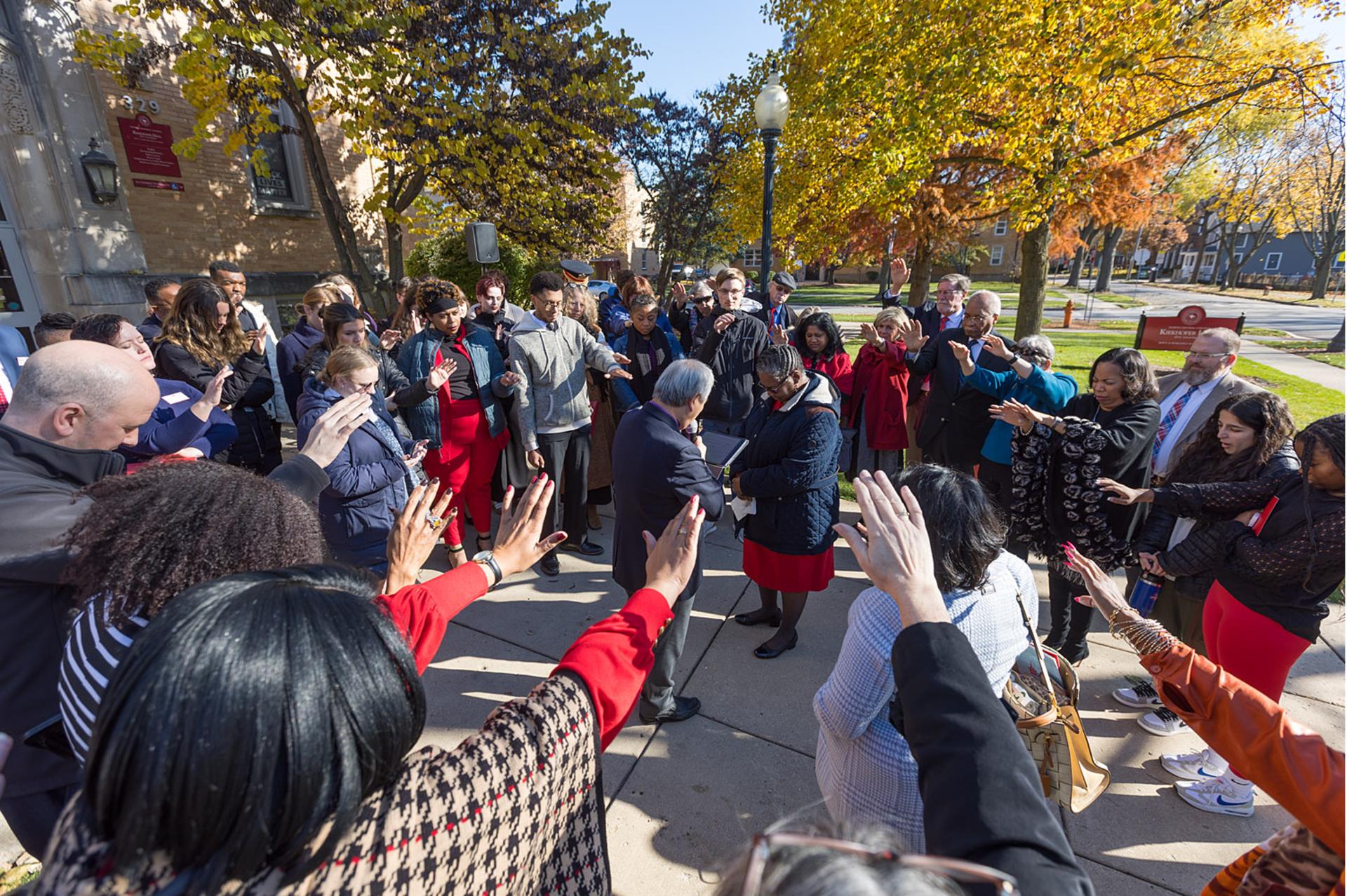 President Thomas is prayed over by the North Central community.