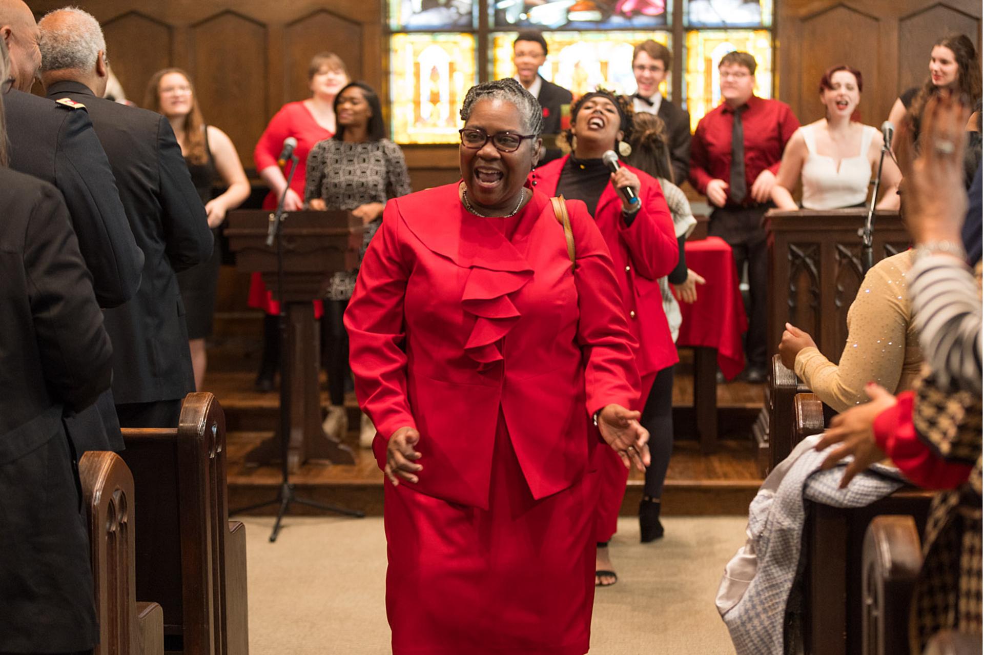 President Anita Thomas singing and dancing.