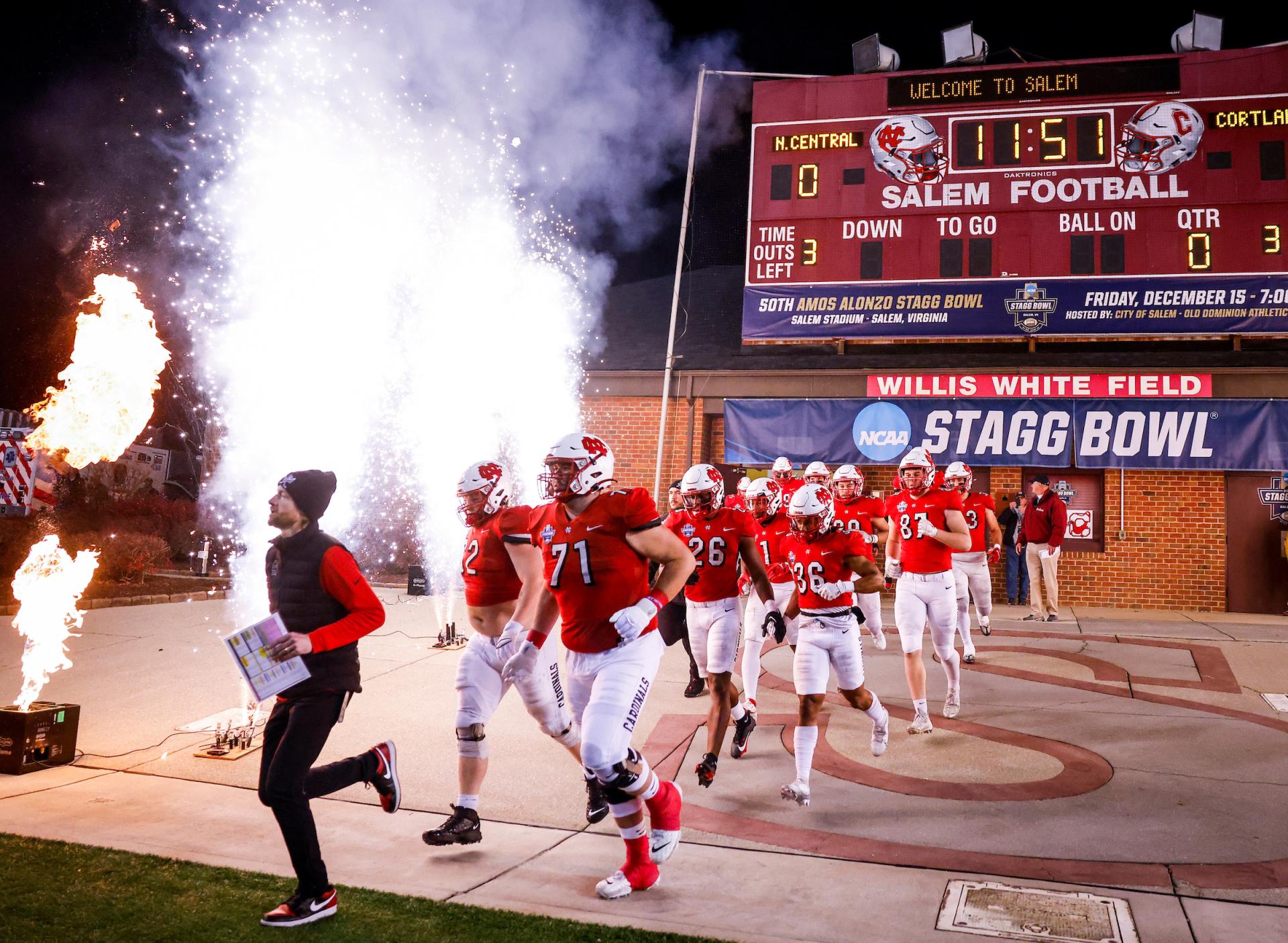 The North Central football team runs out on the field for the Stagg Bowl.