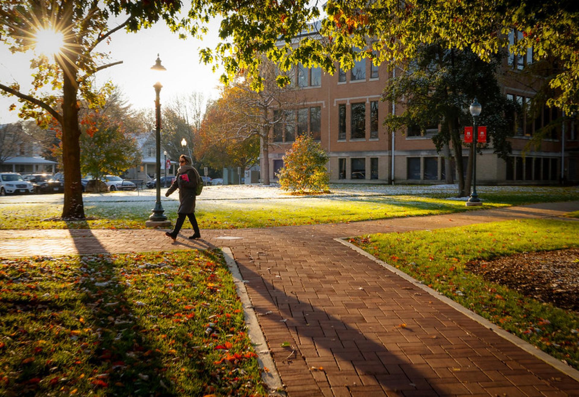 A North Central College student walking from a parking lot to class.