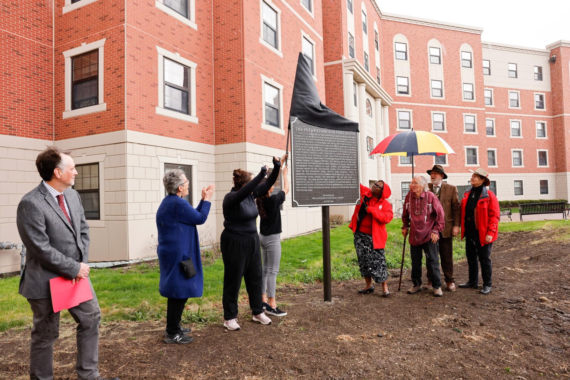 President Anita Thomas unveils the new historical marker at North Central College.