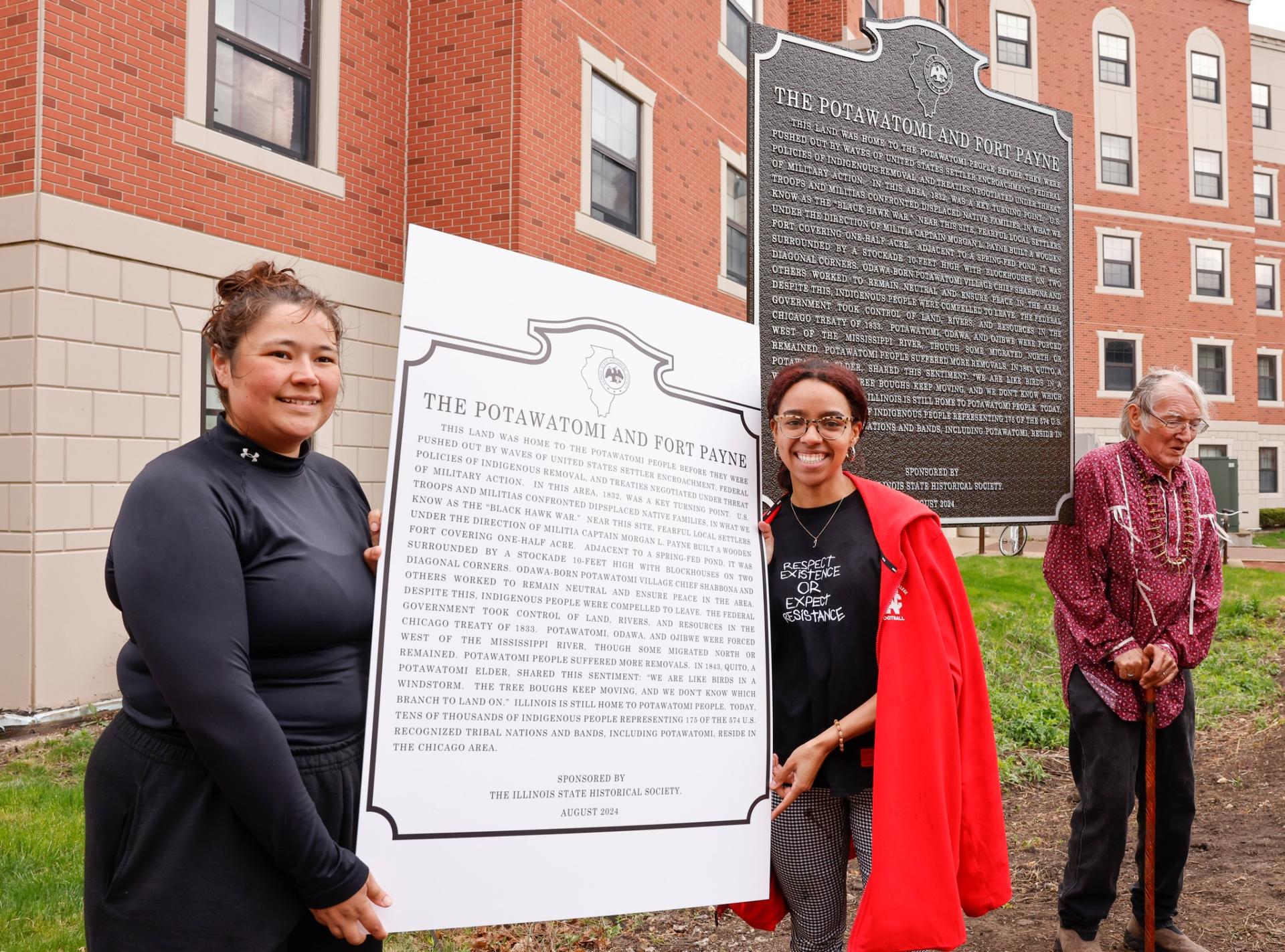 Raygn Jordan with a replica of the historical marker.