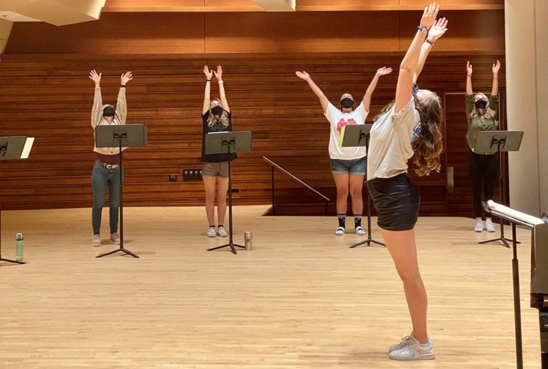 North Central College choral students do yoga to prepare for a rehearsal.