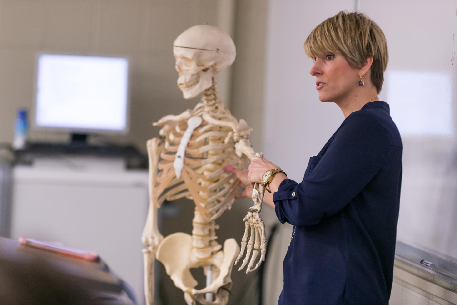 Professor Kendall Selsky teaching using a skeleton.