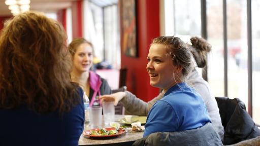 students eating and talking in Kaufman Dining Hall