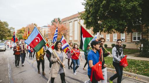 International club carrying flags during homecoming parade