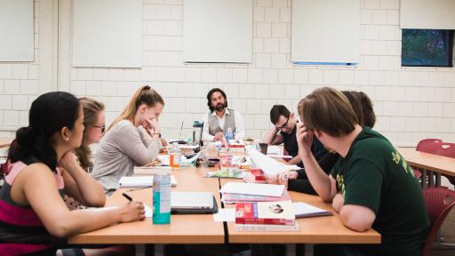 Students sitting around table in classroom