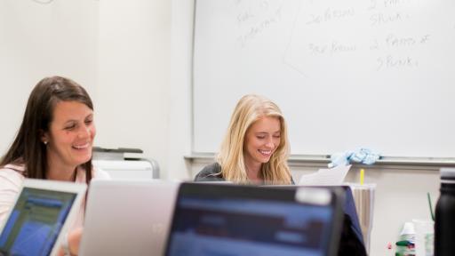 two students researching online