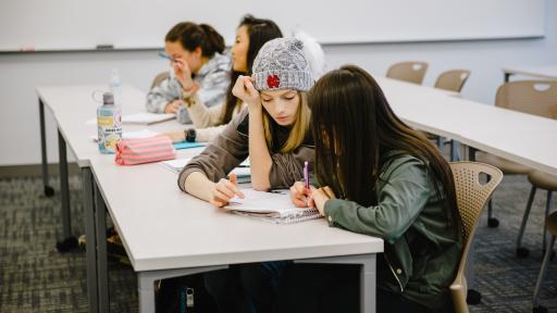 Students in class reading along while listening to lecture