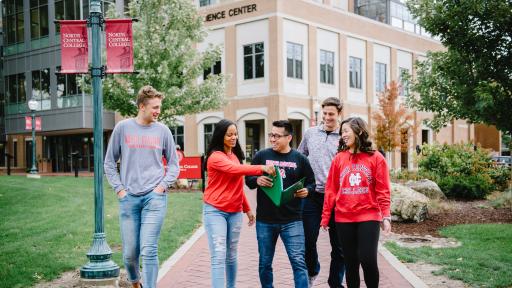 Group of students walking along central campus