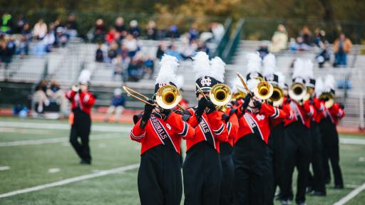 Marching band performing at football game