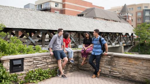 students hanging out at the naperville riverwalk