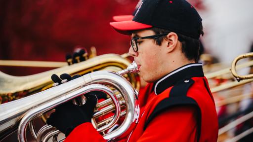 Marching band member performing