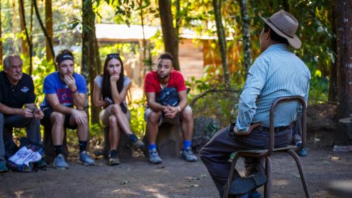 students and coffee farmer talking