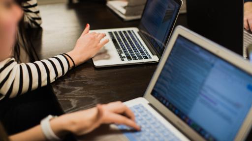 graduate students studying on laptop