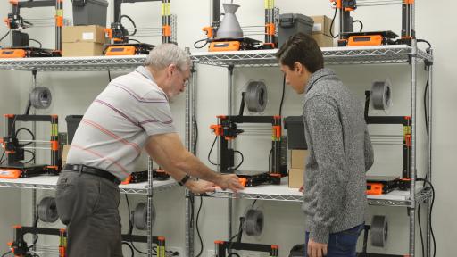 professor and student working with 3D printers