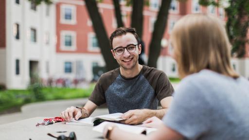 Students outside at a table