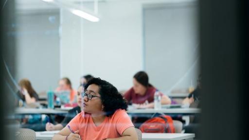 students taking  notes during a lecture