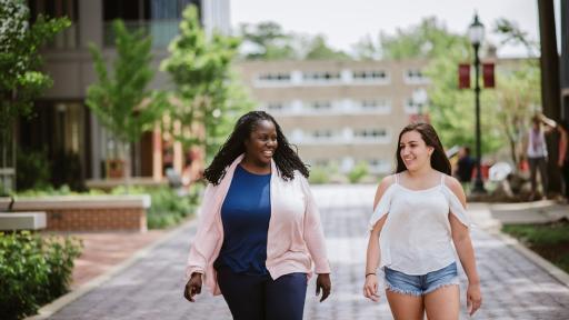 student walking with Dorothy Pleas
