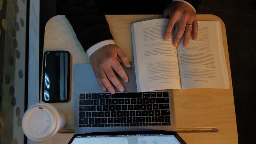 Student with laptop and book