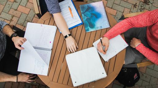 Students with notebook at table