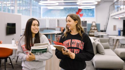 students walking in the library