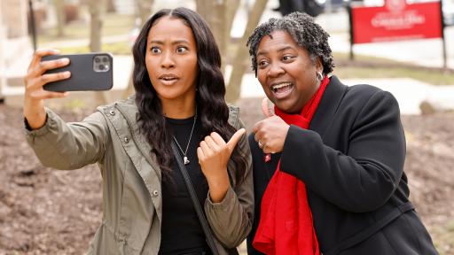 Dr. Anita Thomas, president of North Central College, taking a selfie with a faculty member.