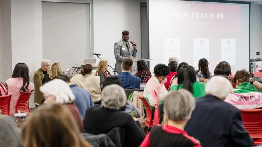 Karl Constant leads a prayer at North Central College's annual MLK Day.