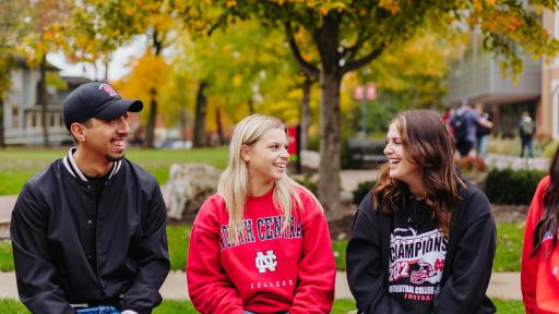 North Central College students talking with one another.