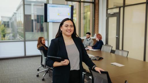 Business student standing in boardroom