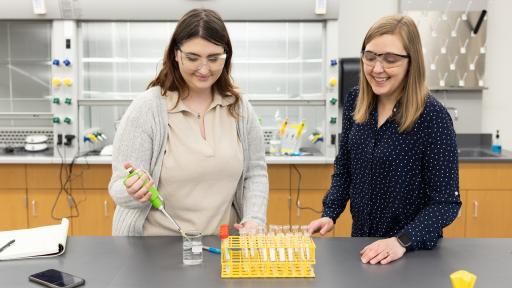 A professor and student are working in a lab on campus.