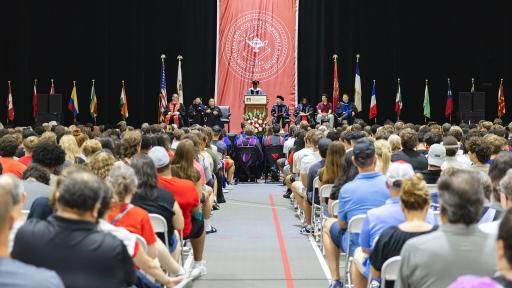 audience filled auditorium listening to a speech