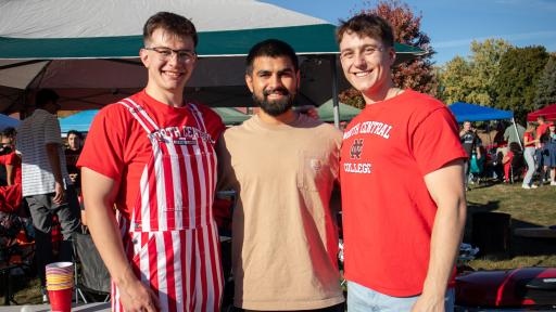 Alums are posing for a photo during Homecoming.