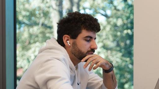 A student working on a laptop on campus.