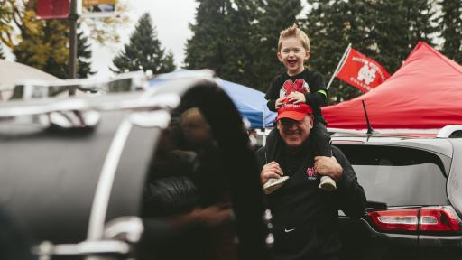 Father and son at homecoming football tailgate