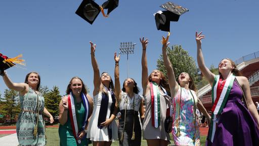 Students throwing their caps in the air after Commencement.