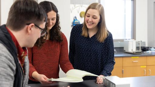 students in laboratory looking at notes