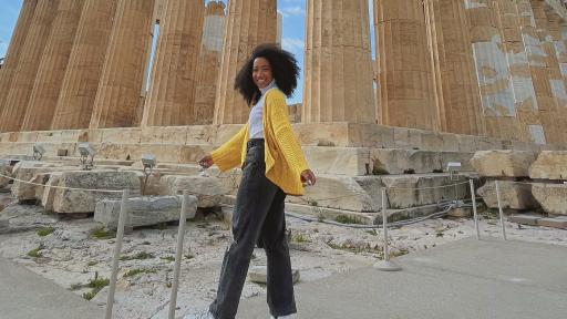 Student posing in front of the Parthenon 
