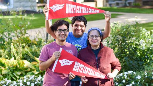 first-gen family posing with NCC flags