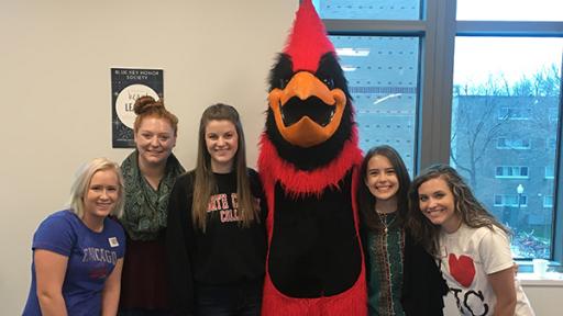 Students in the Blue Key Honor Society meeting with North Central mascot Chippy.
