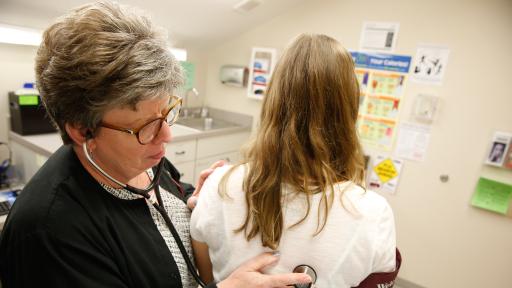 nurse checking heart beat of a patient