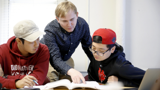 ELI professor pointing at a textbook